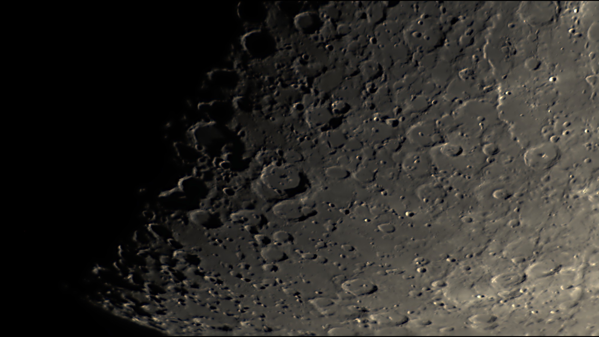 Close-up of the Moon's cratered southern highlands at the terminator, processed in Akastroid