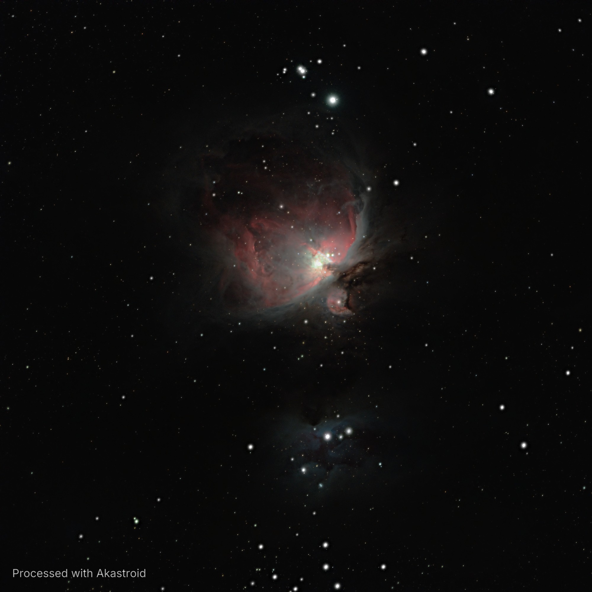 The Orion Nebula M42 with its red and white gas clouds and dark dust, and the blue Running Man Nebula below, processed in Akastroid